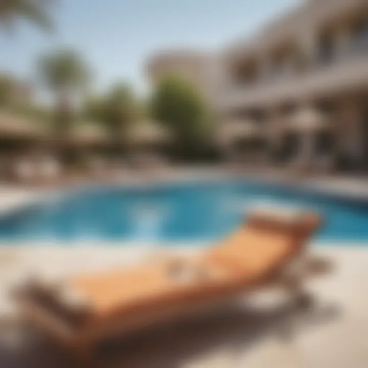 Relaxing poolside area at Jannah Hotel Apartment with sun loungers